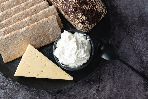 Rye bread crispbread cheese curd cheese in a plate on the kitchen table