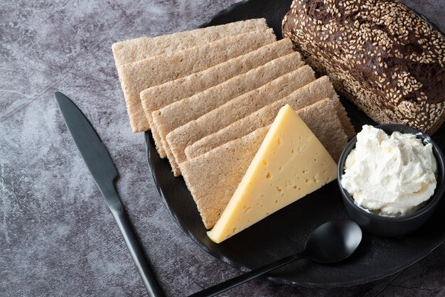 Rye bread crispbread cheese curd cheese in a plate on the kitchen table