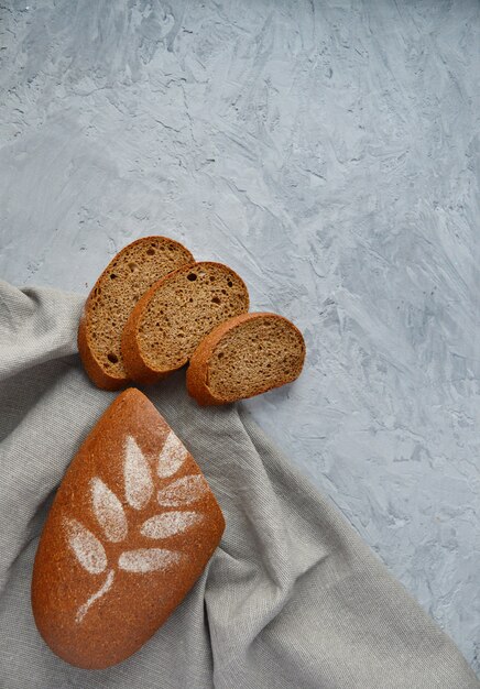 Rye bread on a gray concrete background. copy space. Useful, proper food.