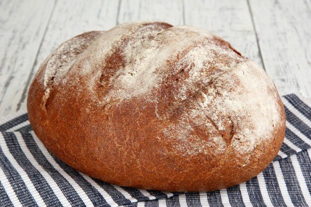 Rye bread on napkin on wooden background