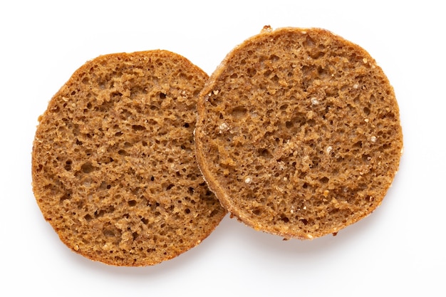 Rye bread slice on a white surface.  Flat lay.