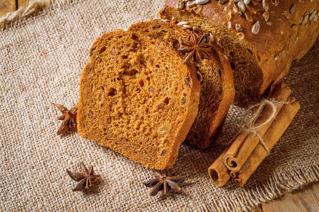 Rye bread next to the sticks of cinnamon and star anise