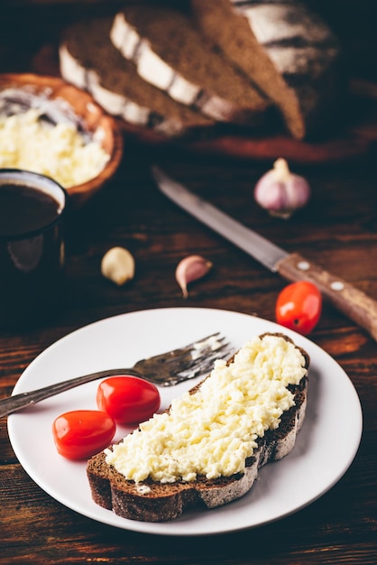 Rye bread toast with processed cheese and garlic