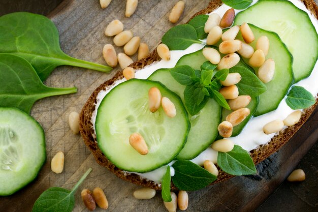 Rye bread with cucumber and pine nuts.