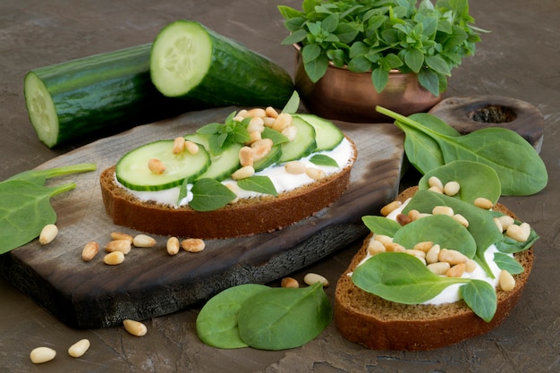 Rye bread with cucumber and pine nuts.