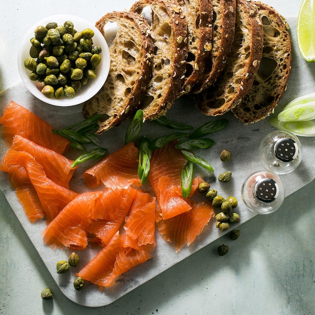 Rye bread with smoked salmon on a marble board winter snack
