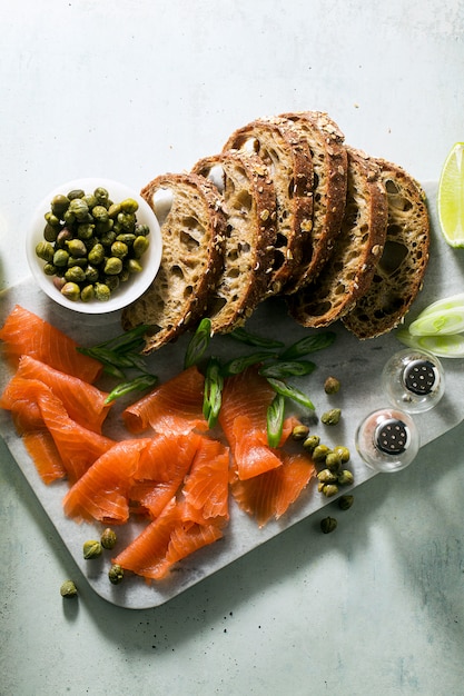 Rye bread with smoked salmon on marble board. winter snack.