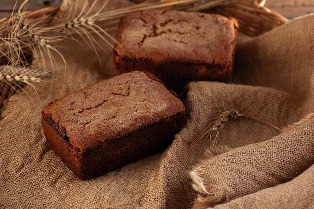 Rye homemade bread on a wicker basket with spikelets