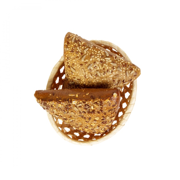 Rye triangle bun sprinkled with seeds on basket