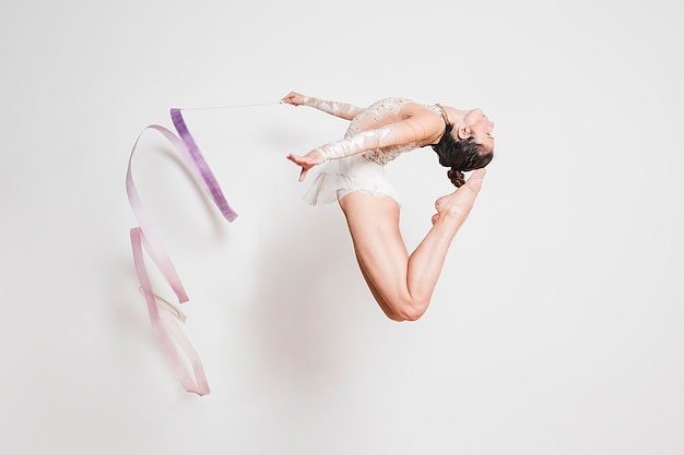 Rythmic gymnast posing with the ribbon