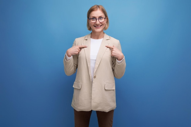 S adult woman with a bob hairstyle in a trendy jacket shows to the side of the banner on a bright