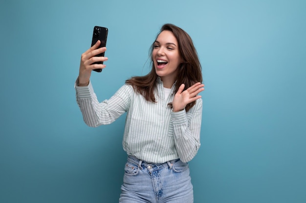 S brunette lady with gorgeous hair makes a call on smartphone connection