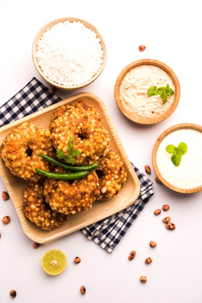 Sabudana vada or Sago fried cake served with peanut chutney over moody background, popular fasting recipe from India.