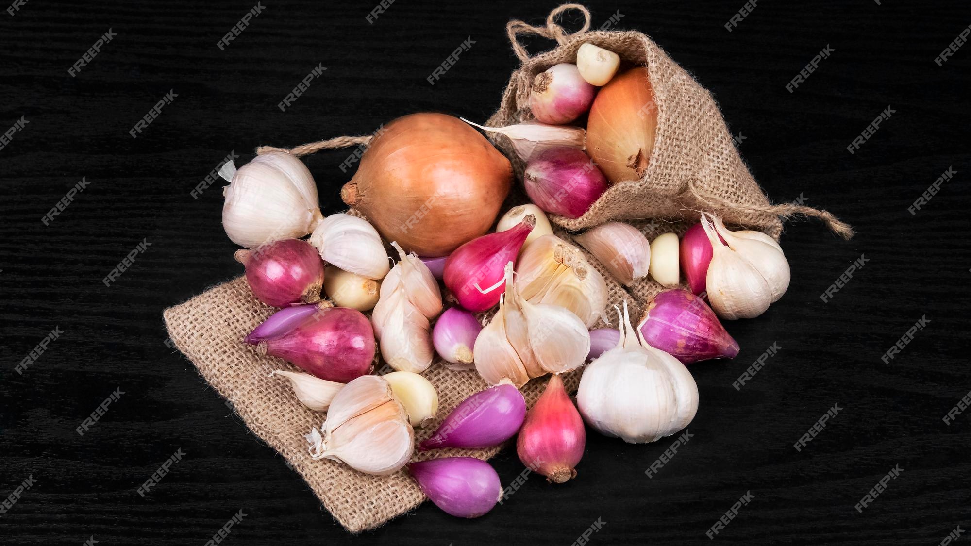 Premium Photo  A sack of garlics shallots and onions