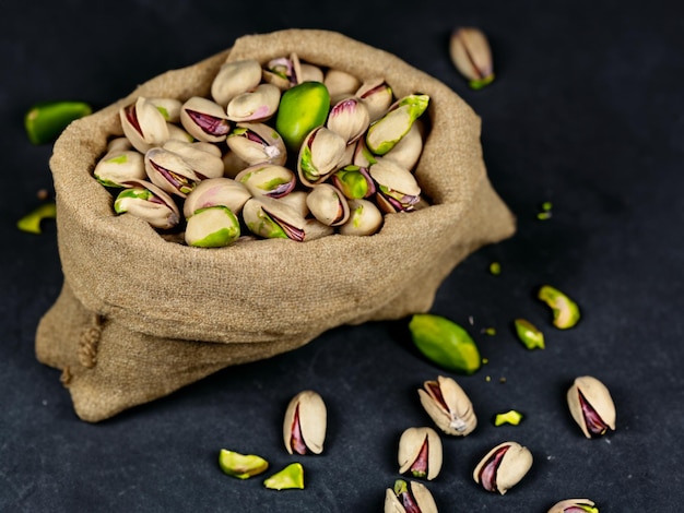 Photo sack with pistachios on a dark background