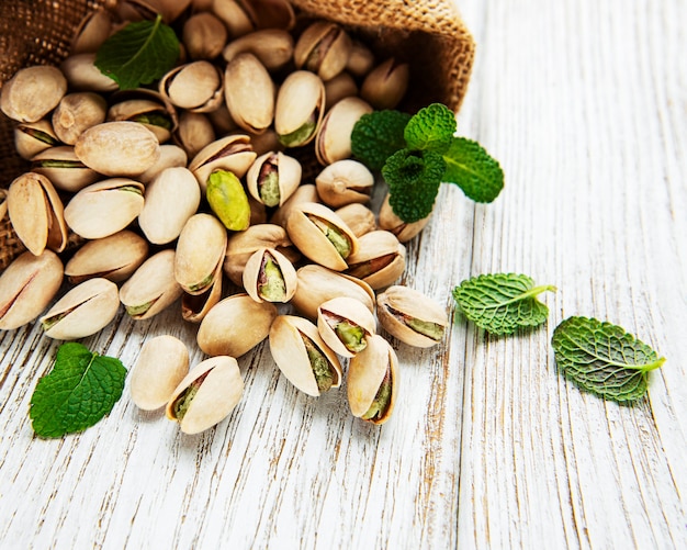 Sack with pistachios on a wooden table