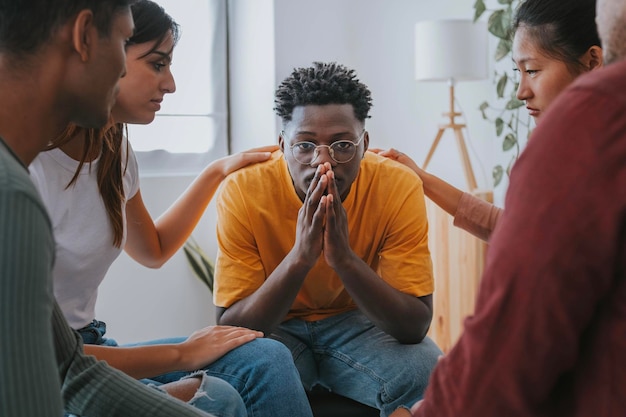 Photo sad african american guy get psychological support of counselor therapist social issue