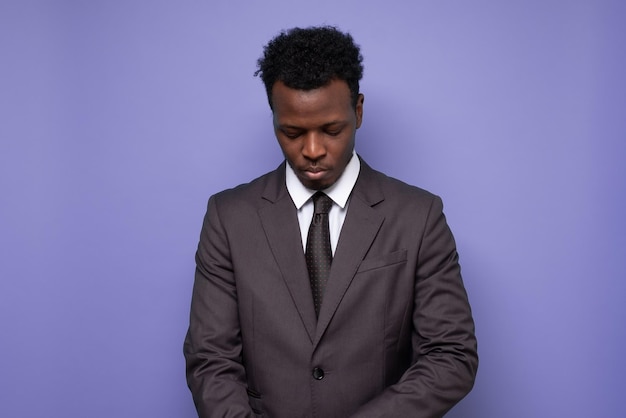 Sad african businessman being tired or exhausted looking down