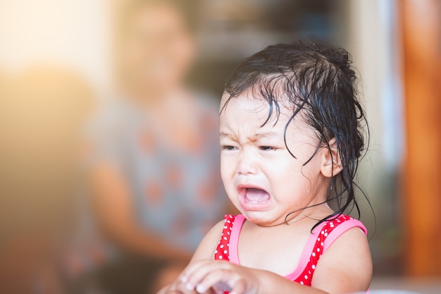 Sad asian little girl crying and upset