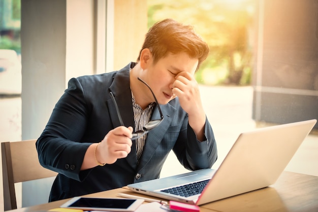 Sad businessman stressed and worried sitting in office. Stress and worry concept. Vintage tone