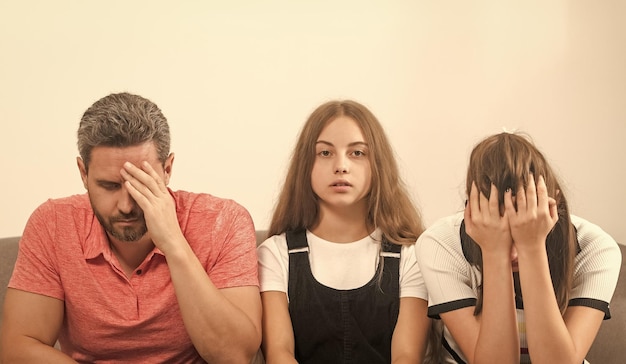 Sad child between mother and father family therapy parents with kid having problems