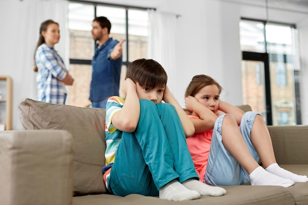 Photo sad children and parents quarreling at home