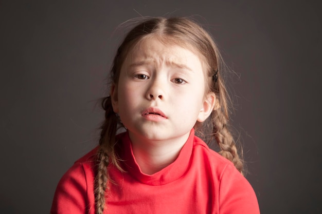 Sad cute girl with pigtails