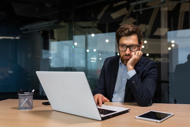 Sad and depressed businessman in depression working inside modern office building man in business