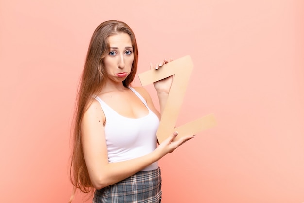 sad, depressed, unhappy, holding the letter Z of the alphabet to form a word or a sentence.