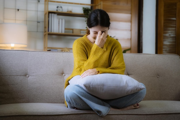 Sad and depressed young female sitting on the sofa sad moodfeel
tired lonely and unhappy concept