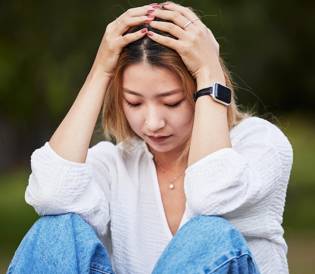 Sad depression and a woman in a park with a mistake thinking and anxiety Tired idea and a girl or person in a garden or field with fear anger or depressed about a problem fail or memory