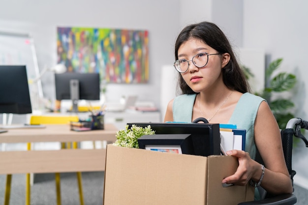 Sad disillusioned disappointed woman in glasses with regret leaves her job in the company