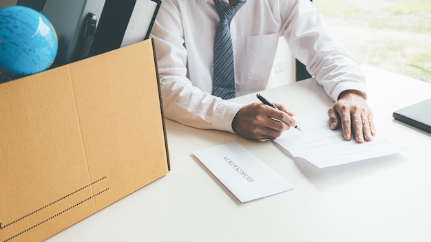 Sad dismissed businessman sitting outside the office after losing his job