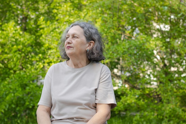 Sad elderly woman reflects on life Wrinkles on the face gray hair Retirement age