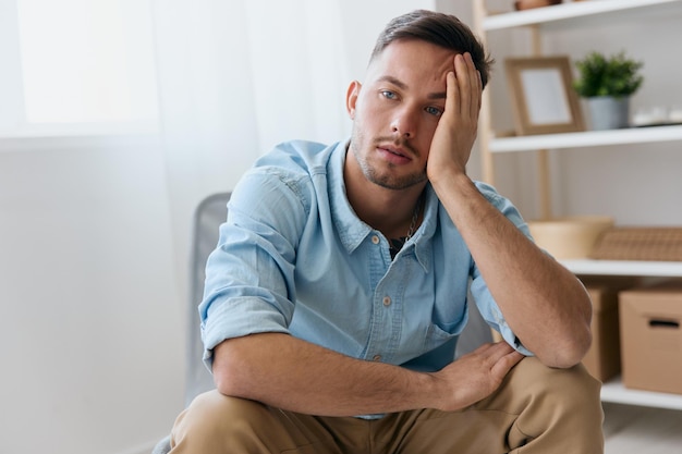 Sad frustrated young man reclines on hand looks aside think\
about difficult life decision bad news health problem upset guy\
have depression need professional psychology help copy space for\
ad