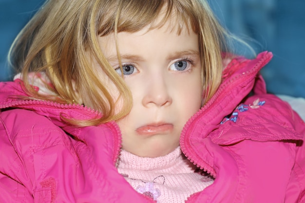 sad gesture blond little girl portrait pink coat