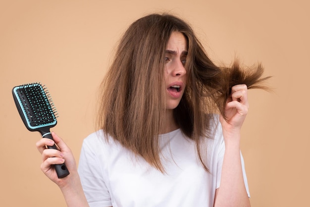 Photo sad girl looking at damaged hair the hair loss problem isolated copy space