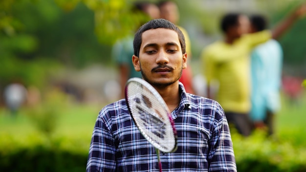 Sad indian man playing badminton