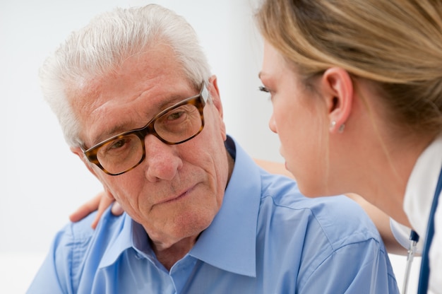 Sad and lonely senior man with nurse