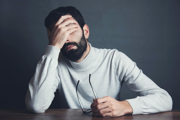 sad man hand in face
