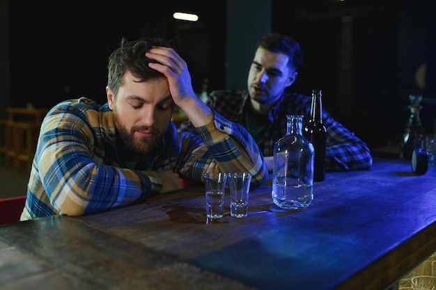 Sad man sitting at bar counter alcohol addiction