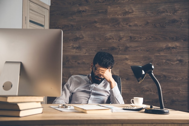 Sad man sitting in office