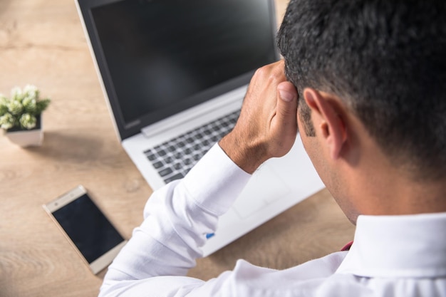 Sad man in working desk