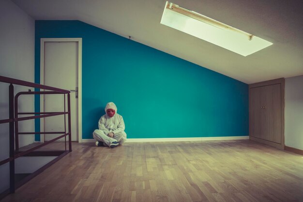 sad, nightmare man with red mask in empty room