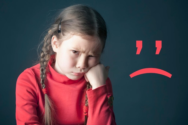 Sad pensive girl with pigtails and with the sad smile mark