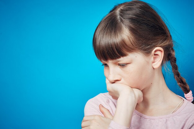 Sad pensive thoughtful girl looking down. emotion and facial expression