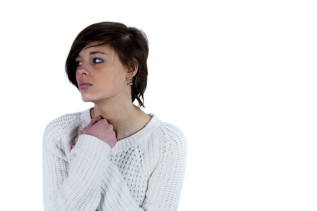 Sad pretty brunette thinking with arms crossed