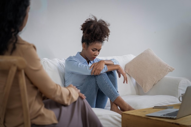 sad ptsd woman patient in crucial therapy for mental health with psychologist