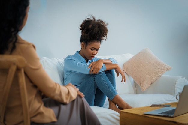 sad ptsd woman patient in crucial therapy for mental health with psychologist
