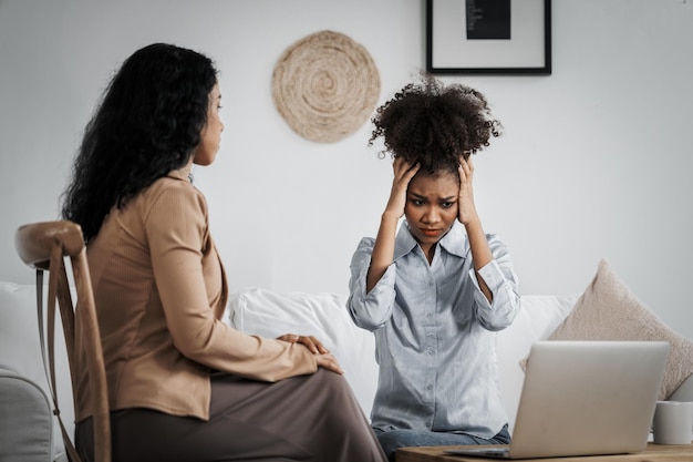 sad ptsd woman patient in crucial therapy for mental health with psychologist